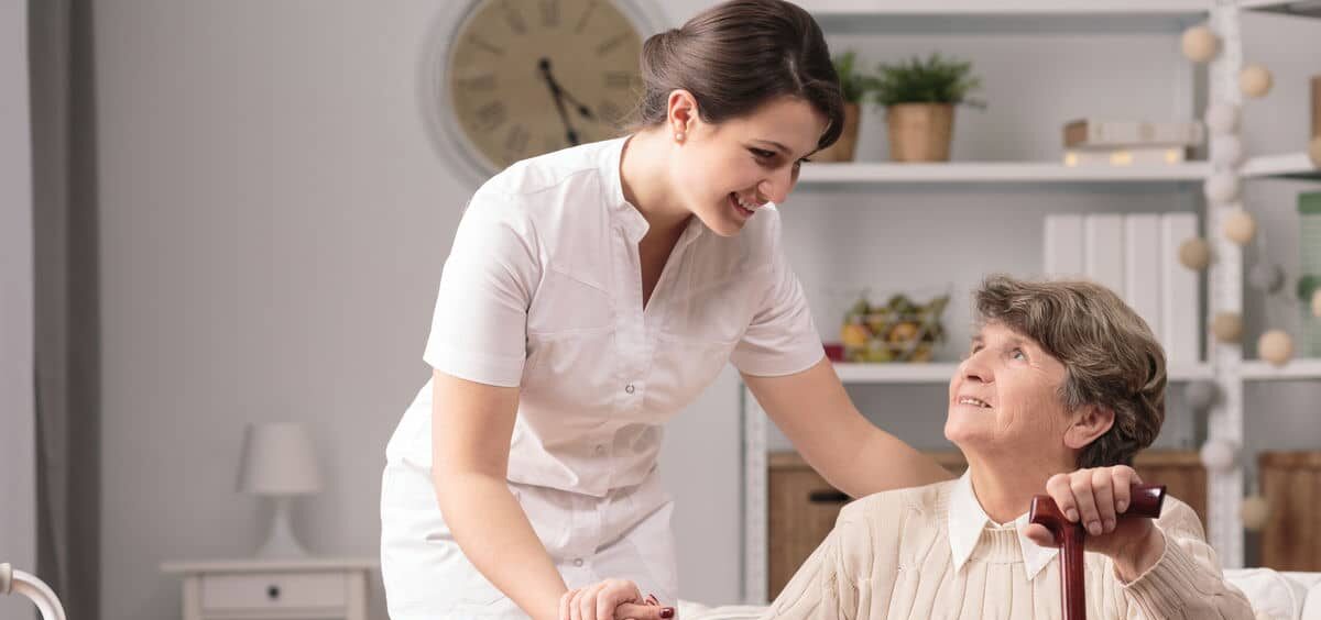 woman caring for senior woman min